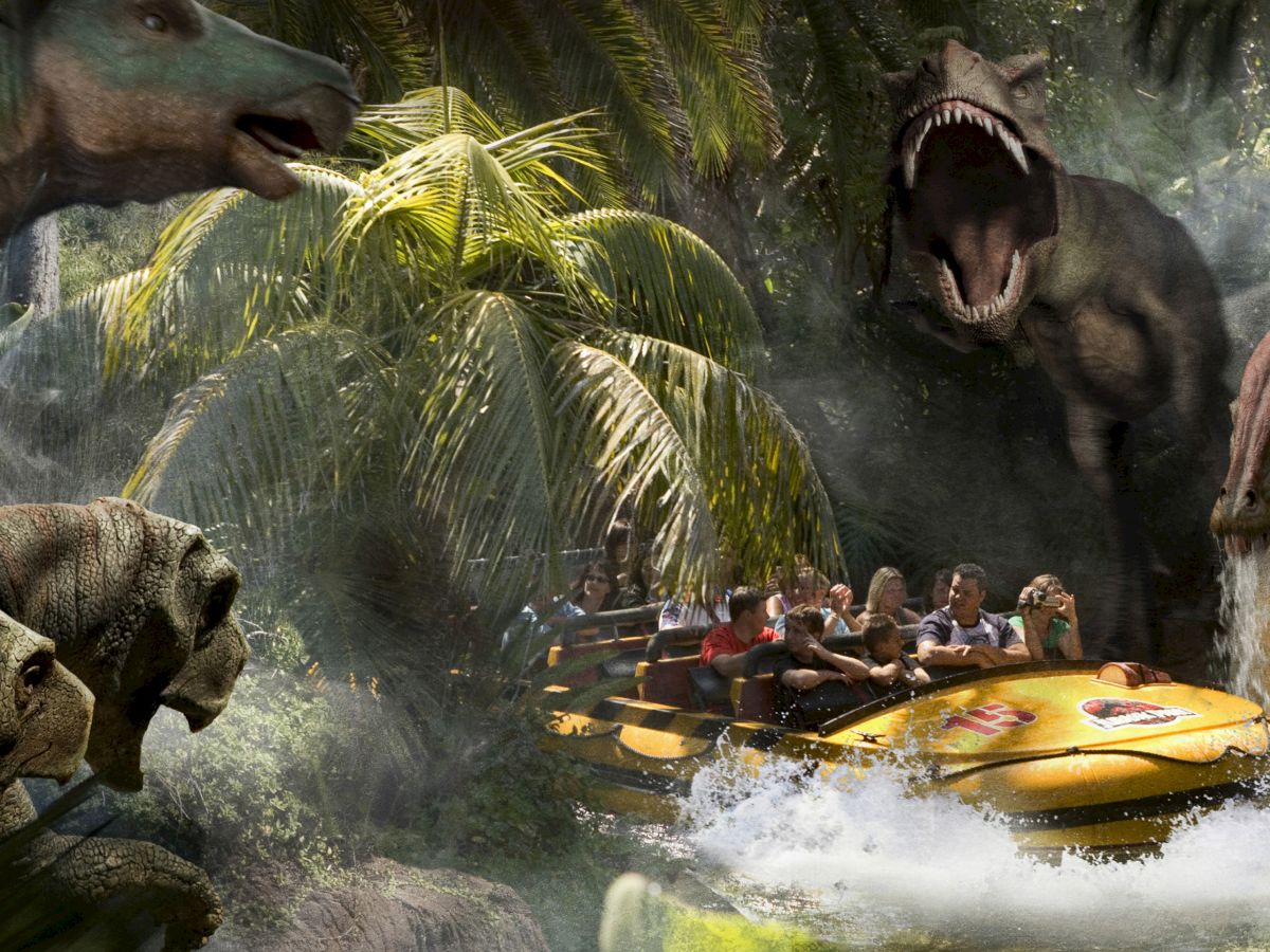 A group of people are riding a water-based attraction surrounded by animatronic dinosaurs in a tropical-themed environment, appearing thrilled and amused.